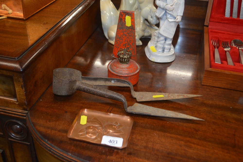 A small metal oil lamp; a pair of shears; and a sm