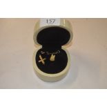 A 9ct gold cross pendant; a gold mounted tooth; an