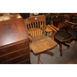 An oak slat back swivel desk chair