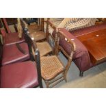 A pair of Victorian rosewood and cane seated bedro