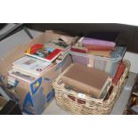 A basket and a box of various books