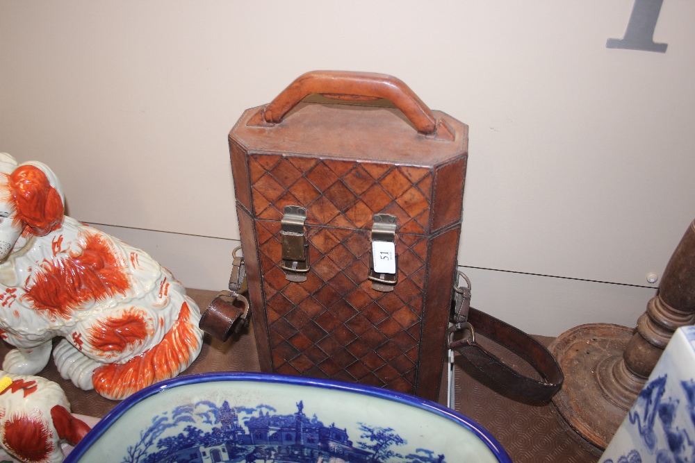 A brown leather bottle carrier