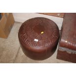 A brown leather pouffe