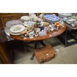 A mahogany oval snap top supper table