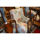 A floral upholstered armchair raised on mahogany s