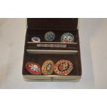 A box containing micro mosaic brooches; and a smal
