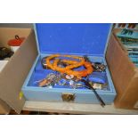 A blue jewellery box containing various costume je