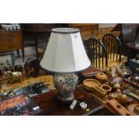 A floral decorated baluster table lamp and shade