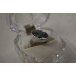 A silver and green stone set signet ring