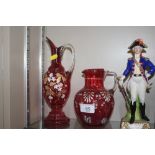 Two Victorian cranberry glass jugs, each with over