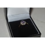 A 18ct gold purple and white stone set ring