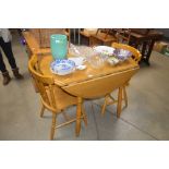 A beech drop leafed dining table and two chairs