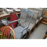 A grey painted stick back armchair
