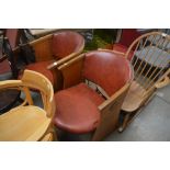 A pair of oak and red leather upholstered chairs