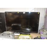 A Sharp flat screen television with remote control