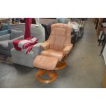 A light brown upholstered swivel chair and matchin