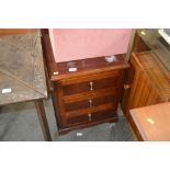 A reproduction three drawer chest