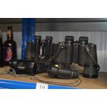 Three pairs of binoculars and an Olympus camera