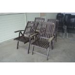 A set of four folding teak armchairs