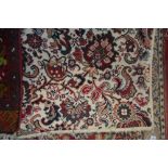 An approx 4' x 2' floral patterned rug