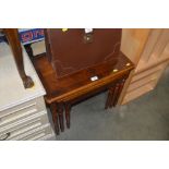 A nest of three veneered occasional tables