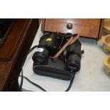 A pair of binoculars in fitted case
