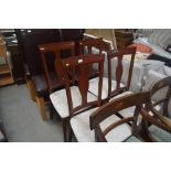A set of four reproduction dining chairs
