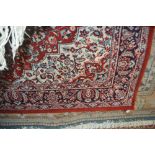 An approx 7'7" x 5'7" floral patterned wool rug