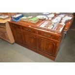 A reproduction yew wood sideboard fitted three dra