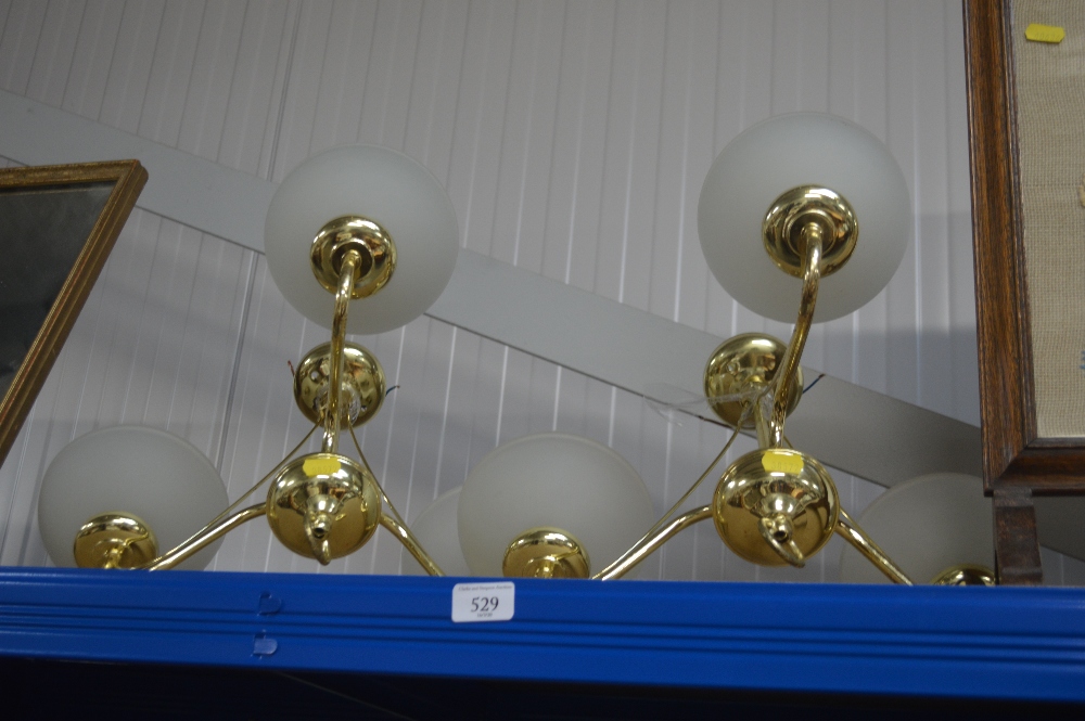 A pair of three branch light fittings