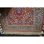 An approx 5'2" x 2'8" floral patterned wool rug