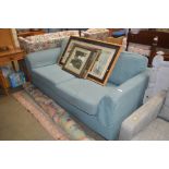 A light blue upholstered two seater settee