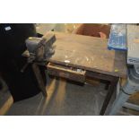 A pine workbench and mounted vice