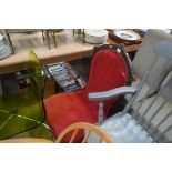 A red upholstered Victorian nursing chair