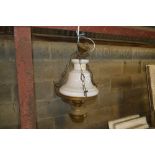 A hanging brass oil lamp converted to electric in