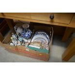 A box of various decorative plates and ornaments e