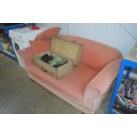A two seater sofa bed with two matching cushions