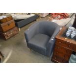 A grey upholstered tub chair