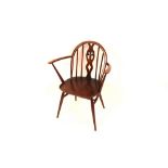 A dark Ercol stick back elbow chair