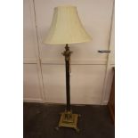 A large brass Corinthian column standard lamp and