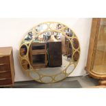 A large circular gilt framed segment wall mirror, with b