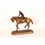 A bronzed horse and jockey figure, 26cm high