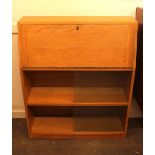 A light oak bureau, of small proportions having gl