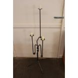 A decorative steel three light candle stand