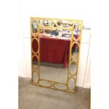 A gilt rectangular sectional wall mirror, with bev