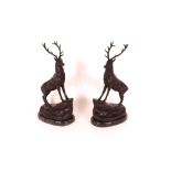 A pair of bronze stag ornaments raised on faux mar