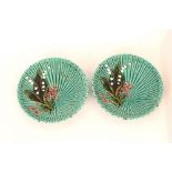 A pair of majolica type green glazed and Lily of t