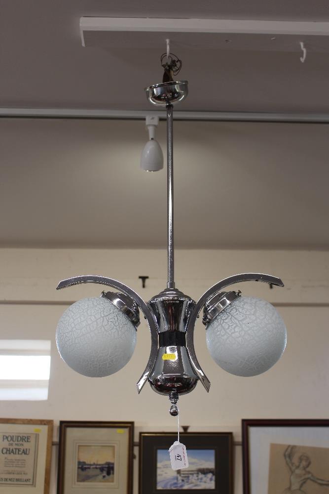 A chrome pendant ceiling light, fitted two frosted