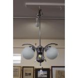 A chrome pendant ceiling light, fitted two frosted
