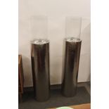 A pair of large chromed pillar candle lanterns